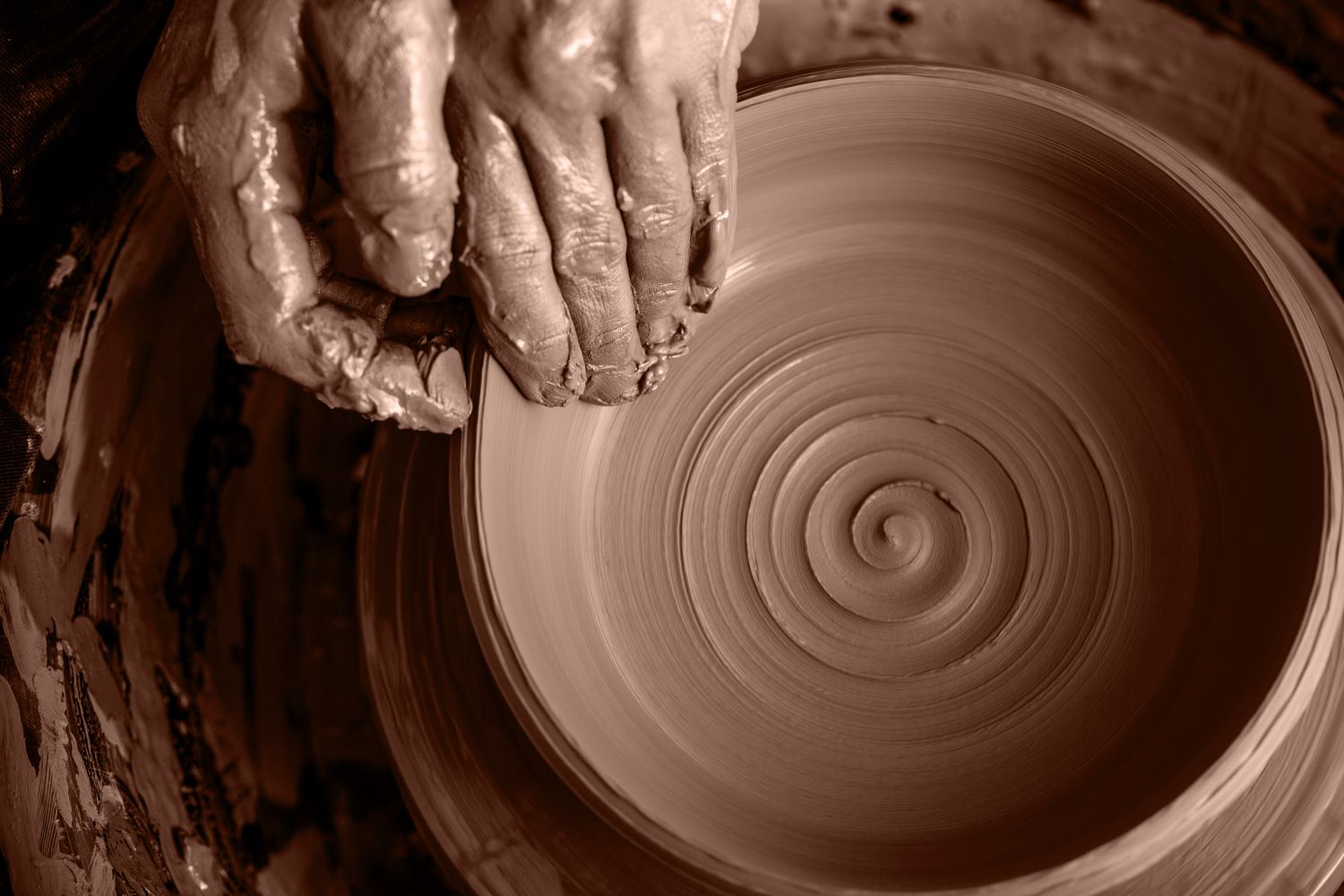 picture of brown clay ceramic spinning on wheel